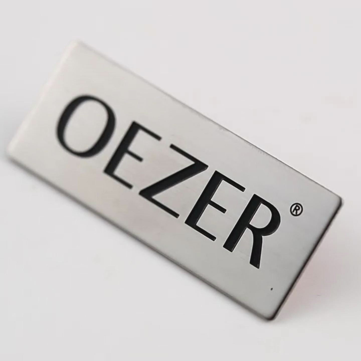 Custom Aluminum Name Tags featuring corporate logo for employee identification